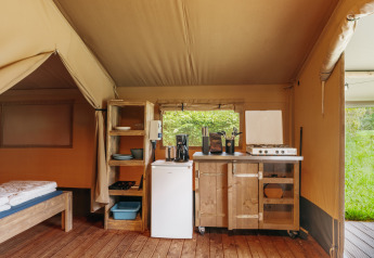 Interior of a safari tent with cozy kitchen setup at Familiepark de Vechtvallei, Netherlands.