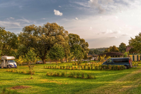 Campeggio Camping Prima nel Sud della Boemia, Repubblica Ceca, con prato verde, alberi, camper e furgone.