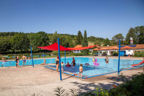 Buitenzwembad bij Camping Walsheim in Saarland, Duitsland, met gezinnen en kinderen in de zon.