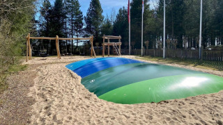 Gran almohada inflable para saltar y columpios en el parque infantil de Tolne Camping, Jutlandia del Norte, Dinamarca.