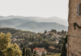 Vista sulle colline e le case da Camping Luna del Monte, un villaggio turistico in Umbria, Italia.