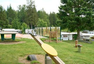 Legeplads med vippe, bordtennisbord og legeredskaber på Camping Braunlage i Niedersachsen, Tyskland.