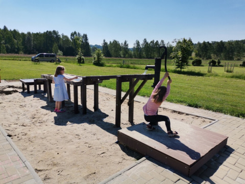 Kinderen spelen met een waterpomp in de zandbak bij Camping de Regenboog, Ústí nad Labem, Tsjechië.