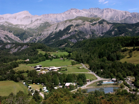 View of Camping Lou Passavous holiday park in Provence-Alpes-Côte d’Azur, France, surrounded by hills and mountains.
