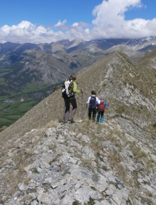 Vandrere på bjergkam med udsigt over dale og bjerge i Provence-Alpes-Côte d’Azur, Frankrig.