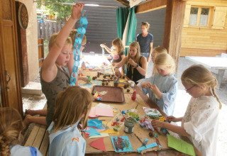 Kinder basteln und malen draußen im Ferienpark Camping Lou Passavous in Provence-Alpes-Côte d’Azur, Frankreich.