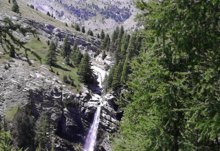 Waterfall in a mountainous, forested landscape near Le Vernet, Provence-Alpes-Côte d’Azur, France.