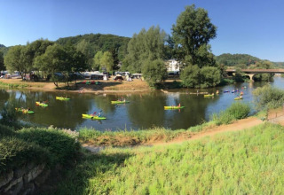 Vista panoramica del fiume con kayak e paesaggio verde al Camping du Rivage, Diekirch, Lussemburgo.
