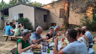Cena al aire libre en Domaine La Sauzette, parque vacacional en Occitanie, Francia, con huéspedes compartiendo.