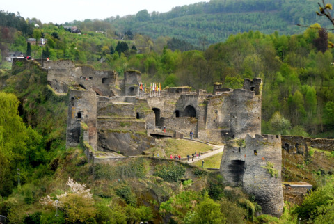 Ruins of a medieval castle surrounded by lush forest near Camping la Roche, Limburg, Belgium.