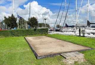 Outdoor petanque court by the marina at Minicamping Marina Warns holiday park in Friesland, Netherlands.