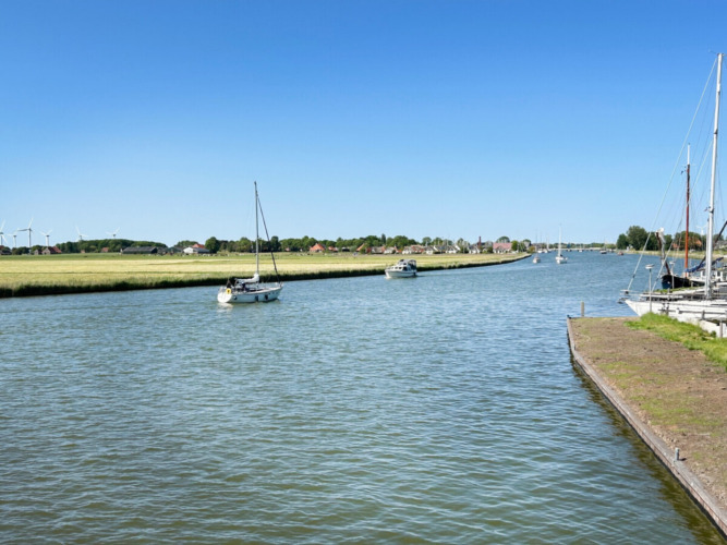 Scenic view of boats on the water at Minicamping Marina Warns holiday park in Friesland, Netherlands.