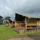 Tiendas safari en Minicamping Marina Warns en Países Bajos, con terrazas de madera y césped verde.