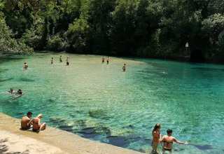 People swim and relax in the clear waters of a natural pool near Narni, Umbria, Italy.