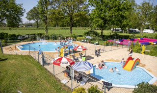 Family-friendly outdoor pool area at Recreation Park Den Blanken featuring slides and relaxing surroundings.