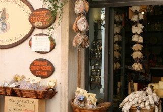 Charming deli shop with local meats and products at the entrance of Camping Il Collaccio, Umbria, Italy.
