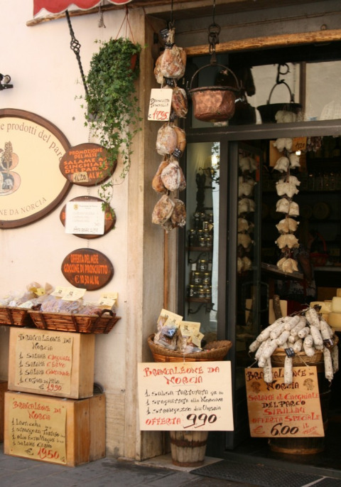 Charming deli shop with local meats and products at the entrance of Camping Il Collaccio, Umbria, Italy.