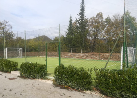 Kleiner Fußballplatz mit Toren und Zaun im Grünen, aufgenommen im Camping Il Collaccio, Umbrien, Italien.