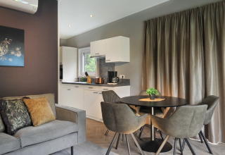 Modern living and kitchen area at Mountain Lodges, featuring elegant decor and comfortable furnishings.