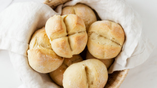Panecillos frescos en una cesta con un paño, una deliciosa especialidad en Camping Kempen en Amberes, Bélgica.