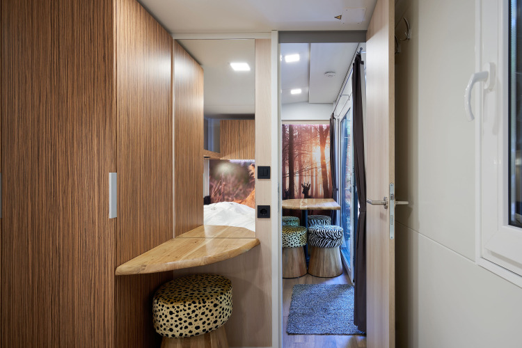 Interior view of SunLodge Katsura featuring wood finishes, window, seating area, and natural decor.