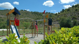 Parco giochi con scivolo e struttura da arrampicata al Camping Saint Amand in Auvergne-Rhône-Alpes, Francia.