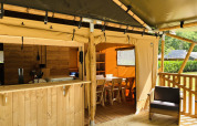 Tienda safari con instalaciones sanitarias privadas y muebles de madera en Familiepark Goolderheide, Bélgica.