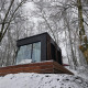 Nokken NKN-18 Cabin at Wilsumer Berge, Germany, set on a snowy hillside surrounded by winter trees.