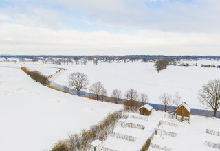 Paysage enneigé avec des cabanes dans les arbres au Holiday Park Mölke, Pays-Bas, vue aérienne en hiver.