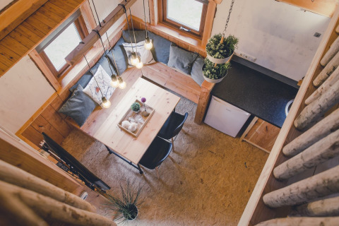 Bird’s-eye view of a cozy tree house at Holiday Park Mölke with dining nook and compact kitchen.
