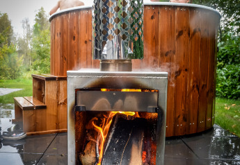 Kinder entspannen im Hot Tub neben einem Holzofen bei Holiday Park Mölke, Niederlande.