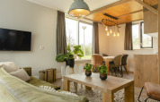 Bright, modern living room in the Baby & children bungalow at Holiday Park Mölke, Netherlands with dining area.