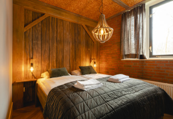 Cozy bedroom at Baby & children bungalow in Holiday Park Mölke, Netherlands, featuring rustic wood decor.