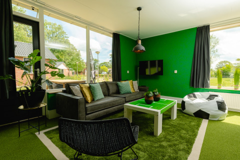 Living room at FC Mölke stadium lodge, Holiday Park Mölke, Netherlands, football-themed décor.