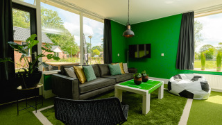 Living room at FC Mölke stadium lodge, Holiday Park Mölke, Netherlands, football-themed décor.