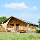 Safari tent Villatent Nomad at Camping Betuwe in the Netherlands, viewed from outside on a sunny grassy area.