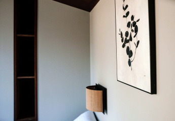 Interior of the Tiny Wellness Cabin at Holiday Park De IJsvogel with wall art, shelf, and wall lamp.