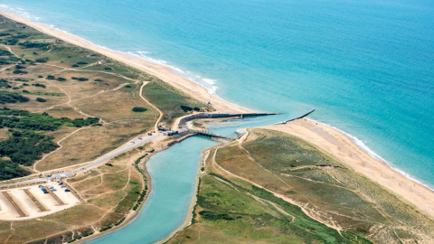 Aerial view of Camping Le Bois de la Gachère in Pays de la Loire, France, showing beach, sea and landscape.