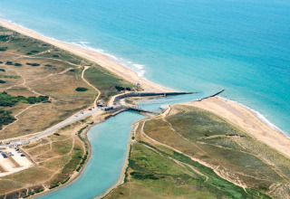 Aerial view of Camping Le Bois de la Gachère in Pays de la Loire, France, showing beach, sea and landscape.