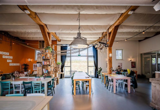 Espace commun lumineux de la Safari tent Cozy à TinyParks Cast Away aux Pays-Bas, ambiance chaleureuse.