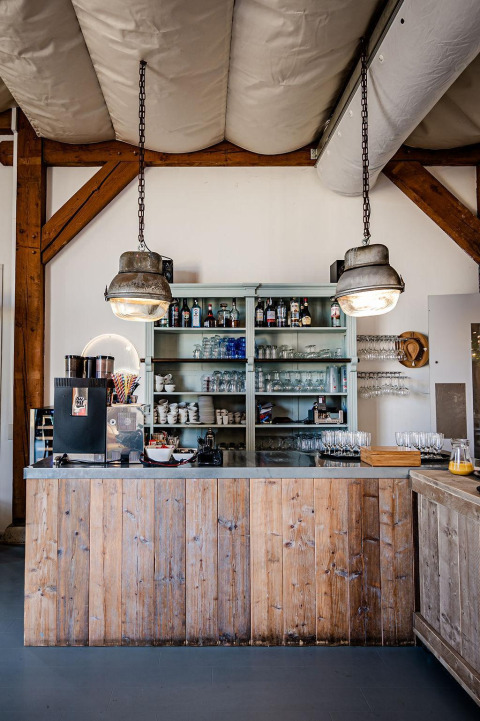 Rustic coffee bar and shelves in a safari tent at TinyParks Cast Away, Netherlands, with breakfast setup.
