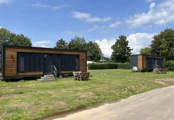 Two modern tiny houses at Tiny House lodge in Recreation park and Marina Rhederlaagse Meren, Netherlands.