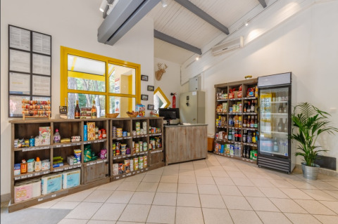 Modern camp store with drinks and groceries at Camping Le Bois de la Gachère, Pays de la Loire, France.