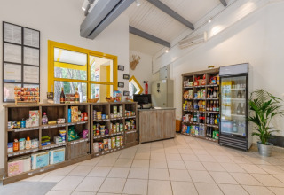Modern camp store with drinks and groceries at Camping Le Bois de la Gachère, Pays de la Loire, France.