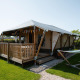 Villatent Cottage lodge with wooden deck and hammock at Camping de Molenhoek, Netherlands, outdoor view.