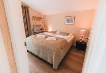 Dormitorio en Cabin on the Hill en Wilsumer Berge, Alemania, con cama doble y luz ambiental suave.