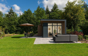 Lodge moderno con ampie finestre, patio e arredi da giardino nel Veluwepark de Bosgraaf, Paesi Bassi.