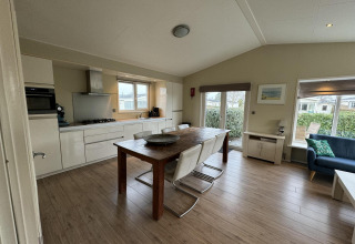 Cocina y sala de estar moderna y luminosa en la cabaña Velthorst de EuroParcs Parc du Soleil, Países Bajos.