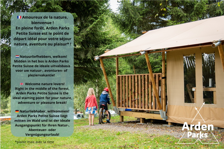Two children and an adult by a luxury glamping tent in the forest at Arden Parks Petite Suisse, Belgium.