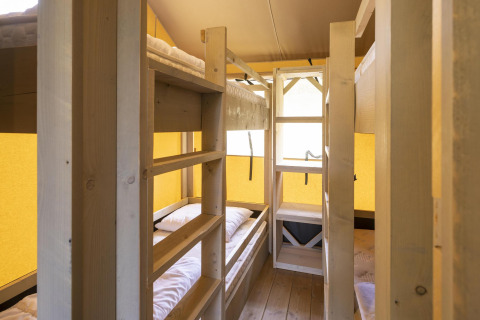 Indvendig billede af Ranger Lodge safari-teltet på Baalse Hei i Belgien med køjesenge og træinteriør.